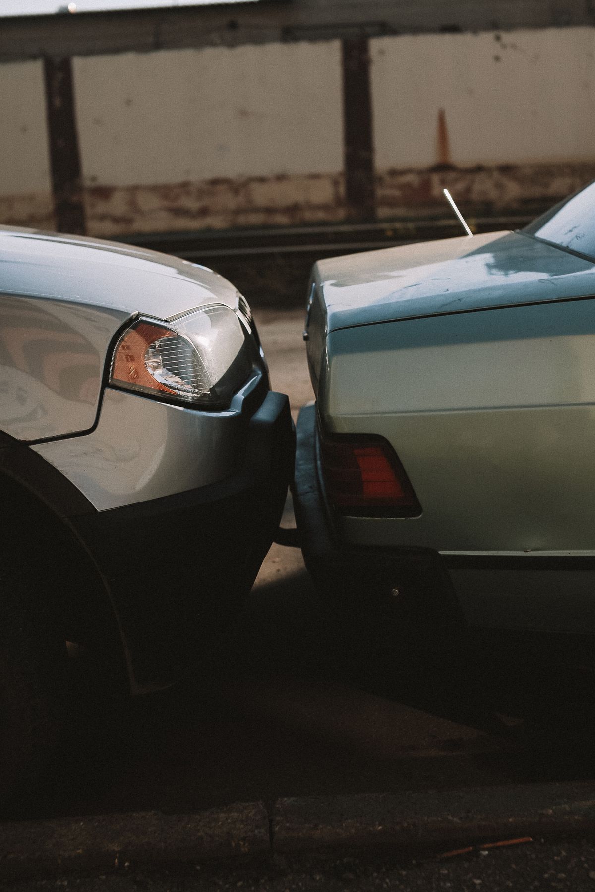 Close-up of a rear-end collision, two vehicles bumper to bumper